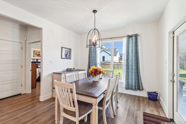 dining room featuring hardwood / wood-style floors and a chandelier