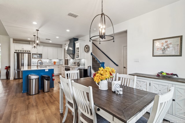 dining area featuring sink and dark hardwood / wood-style flooring