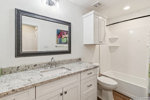 full bathroom with vanity, toilet, hardwood / wood-style flooring, and  shower combination