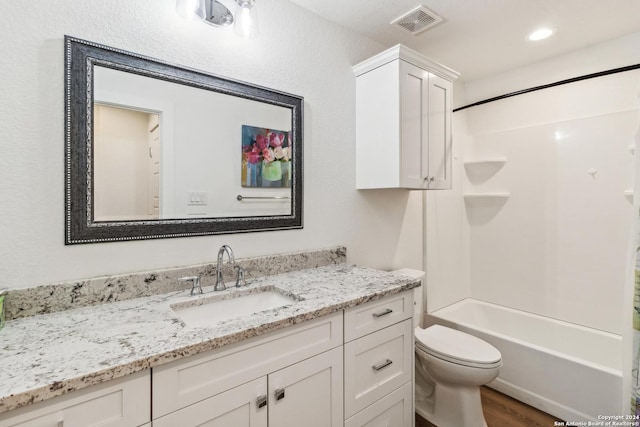 153 W Magnolia Cir, La Vernia, TX 78121 - bathroom with wood finished floors, vanity, toilet, shower / washtub combination, and recessed lighting