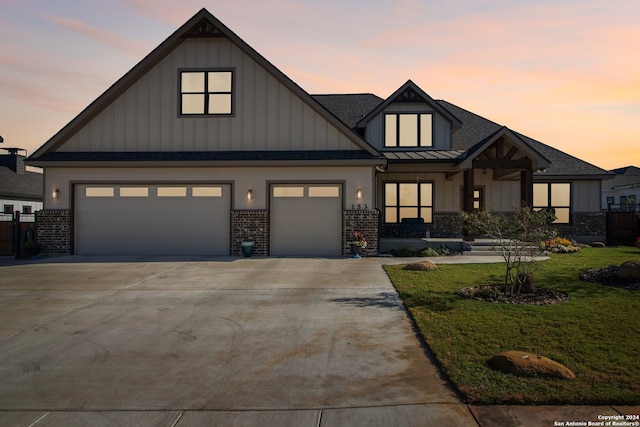 view of front facade featuring a garage and a lawn