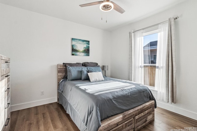 153 W Magnolia Cir, La Vernia, TX 78121 - bedroom featuring baseboards, dark wood-style flooring, and a ceiling fan