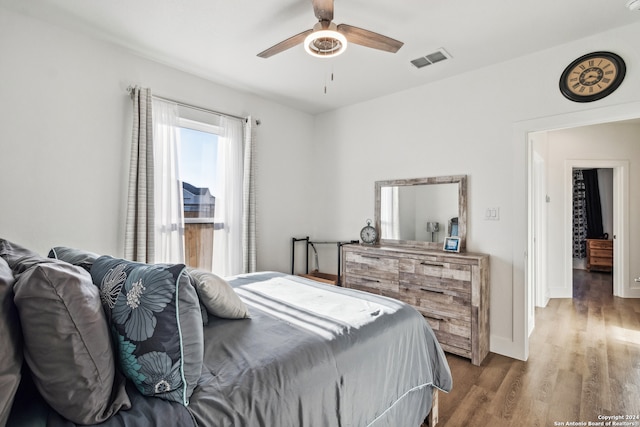 bedroom with wood-type flooring and ceiling fan