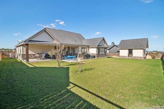 back of house featuring a patio and a lawn