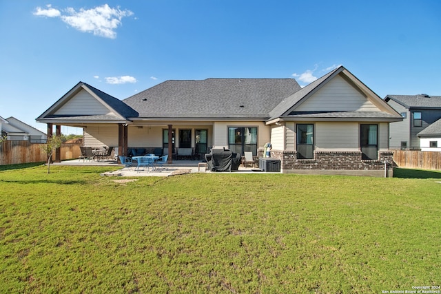 rear view of house with a patio area, central AC, and a lawn