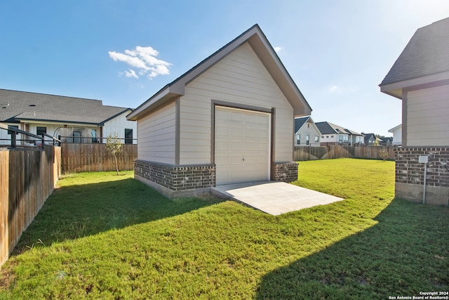 exterior space with a garage and a lawn