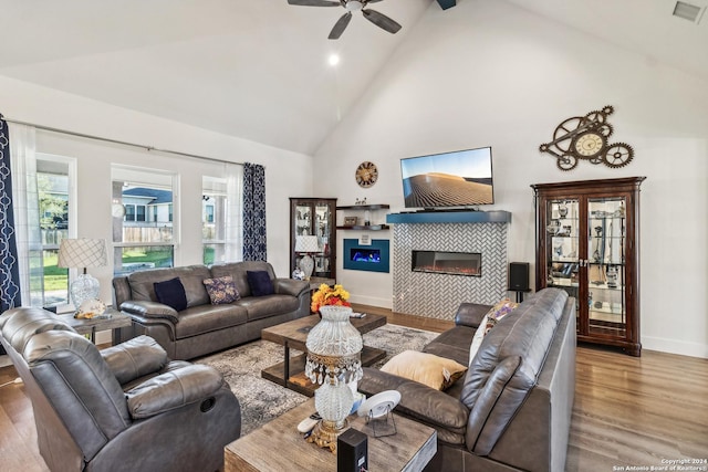 153 W Magnolia Cir, La Vernia, TX 78121 - living area with a fireplace, wood finished floors, high vaulted ceiling, ceiling fan, and baseboards