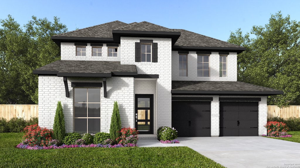 view of front of home featuring a front yard and a garage