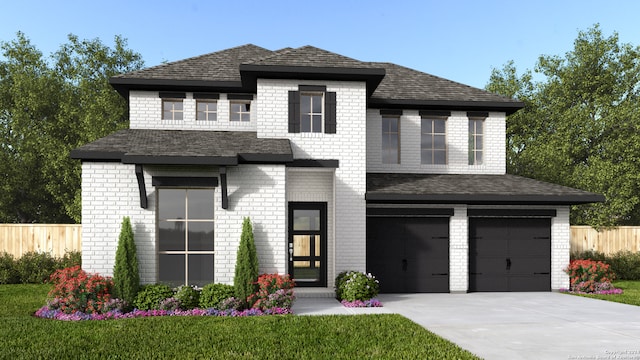 view of front of home featuring a front yard and a garage