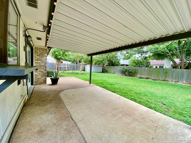 view of patio featuring a storage unit