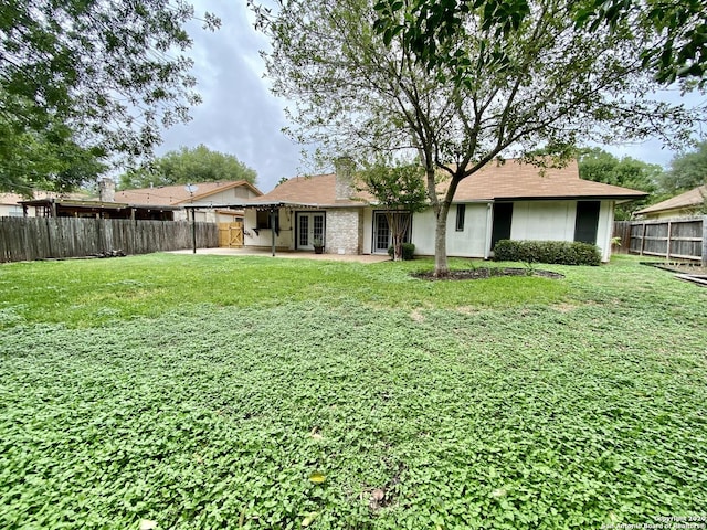 back of property featuring a patio area and french doors