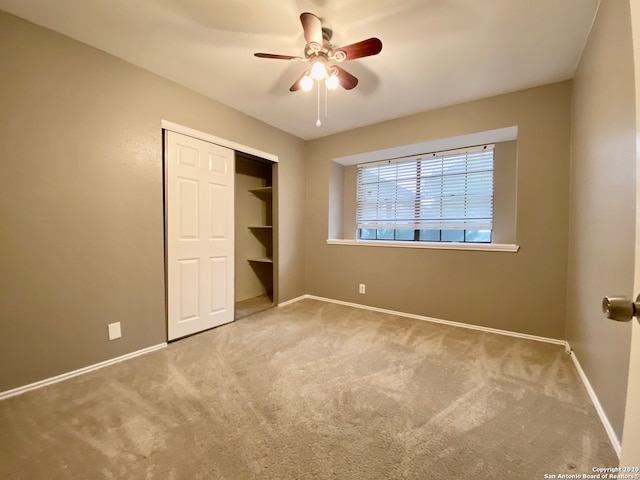 unfurnished bedroom featuring a closet, ceiling fan, and carpet