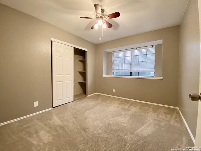unfurnished bedroom with carpet floors, baseboards, and a closet