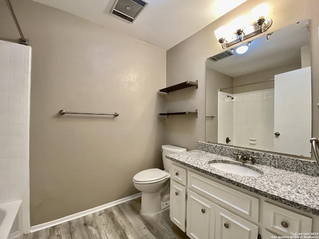 full bath featuring wood finished floors, toilet, vanity, baseboards, and  shower combination