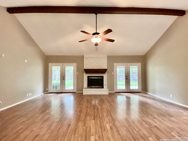 unfurnished living room with beam ceiling, french doors, light wood-type flooring, and ceiling fan