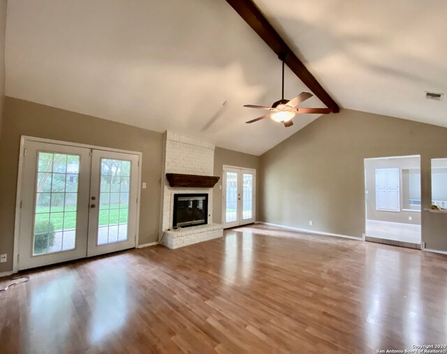 unfurnished living room with french doors, light hardwood / wood-style floors, and a healthy amount of sunlight