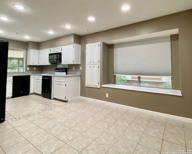 kitchen with light stone countertops, black appliances, white cabinetry, and light tile patterned flooring