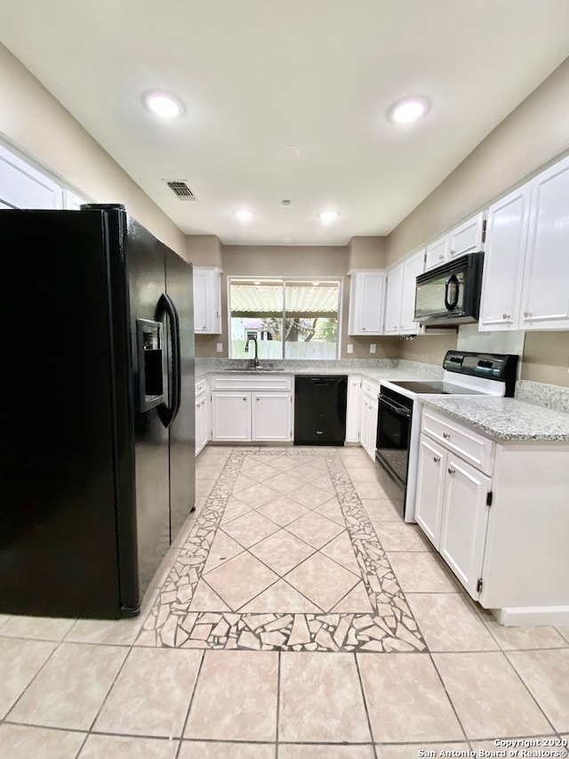 kitchen with black appliances, sink, and white cabinets