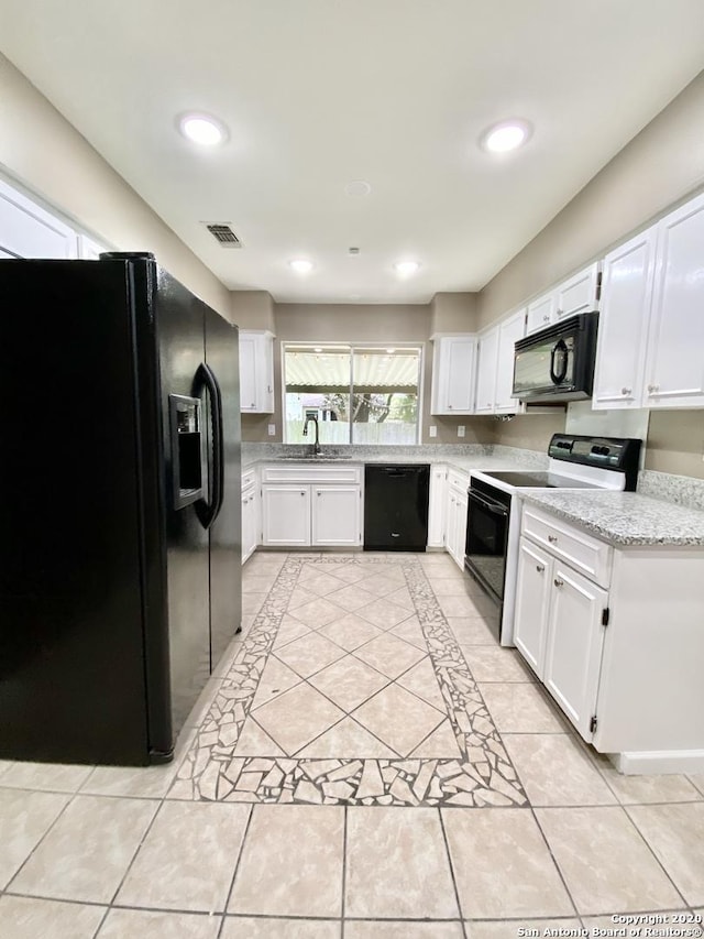 kitchen featuring black appliances, white cabinetry, a sink, light tile patterned floors, and recessed lighting
