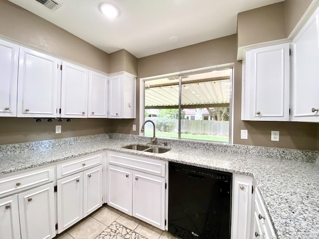 kitchen with black dishwasher, a sink, white cabinetry, light tile patterned flooring, and light stone countertops