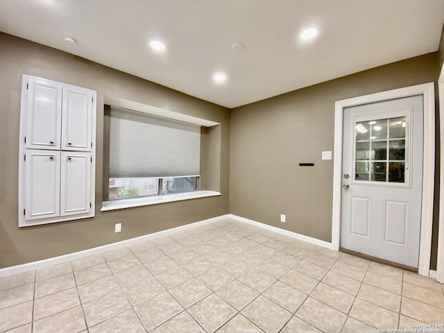 spare room with baseboards and recessed lighting