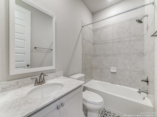 full bathroom with vanity, tiled shower / bath, and toilet