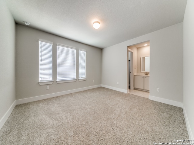 carpeted spare room featuring a textured ceiling