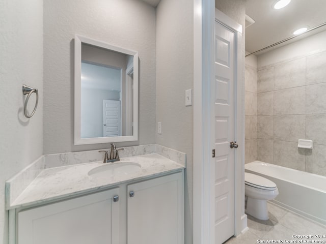 full bathroom with vanity, tiled shower / bath combo, toilet, and tile patterned floors