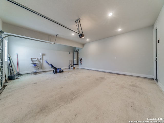 garage with a garage door opener and water heater