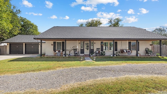 single story home featuring a front yard, a garage, and a porch