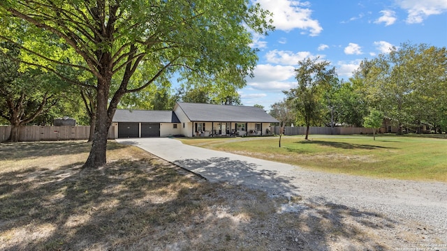 single story home with a front yard and a garage