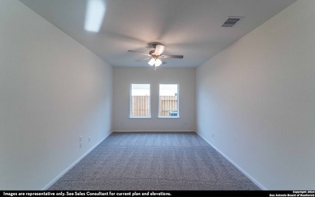 empty room with light colored carpet, visible vents, ceiling fan, and baseboards