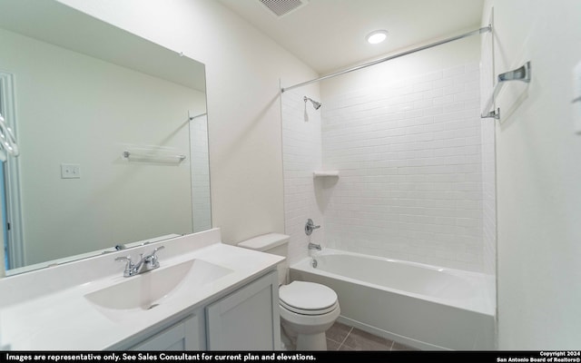 full bathroom featuring toilet, tiled shower / bath, vanity, and tile patterned floors