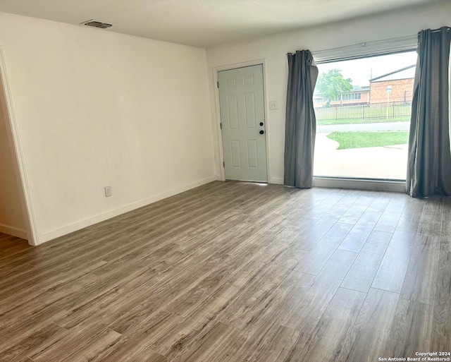 unfurnished room with hardwood / wood-style floors