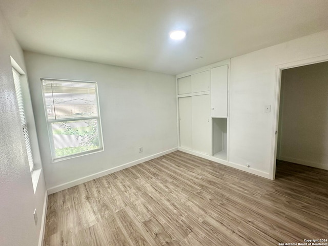 unfurnished bedroom featuring a closet and light hardwood / wood-style flooring