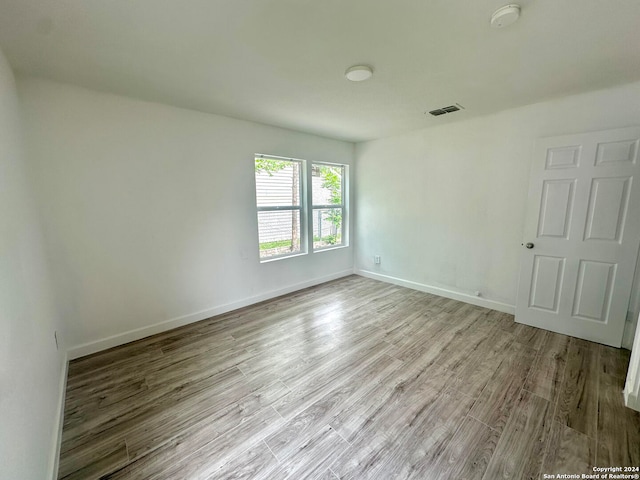 unfurnished room with light hardwood / wood-style flooring