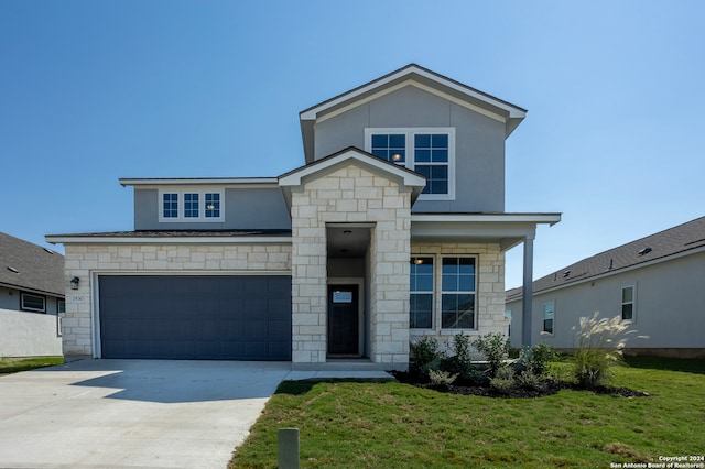 view of front of house with a front yard and a garage