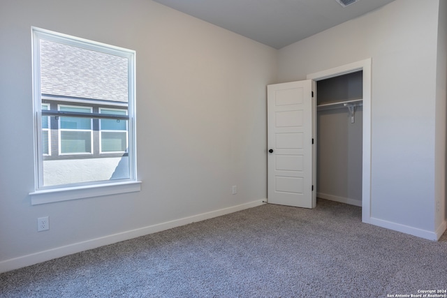 unfurnished bedroom featuring carpet floors and a closet