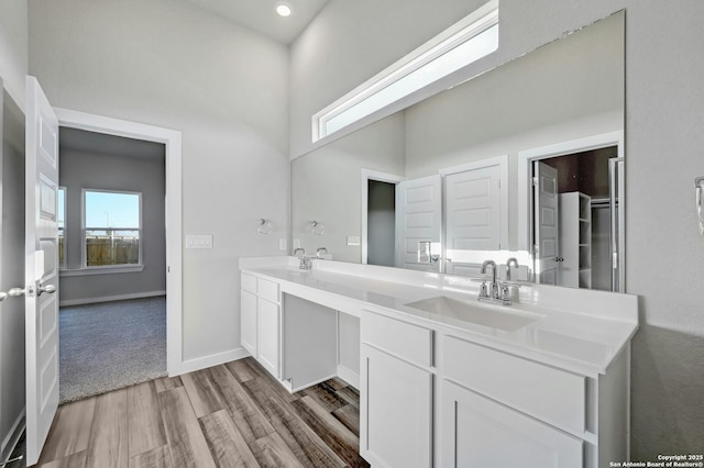 bathroom featuring a healthy amount of sunlight, hardwood / wood-style floors, and vanity