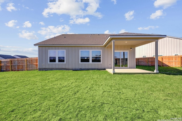 rear view of house featuring a patio area and a lawn