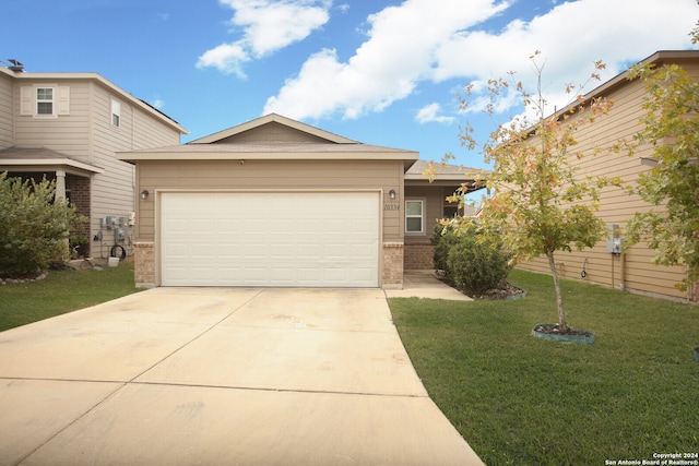 view of front of property featuring a garage and a front lawn