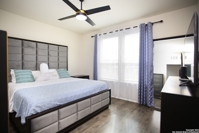 bedroom with dark hardwood / wood-style floors and ceiling fan