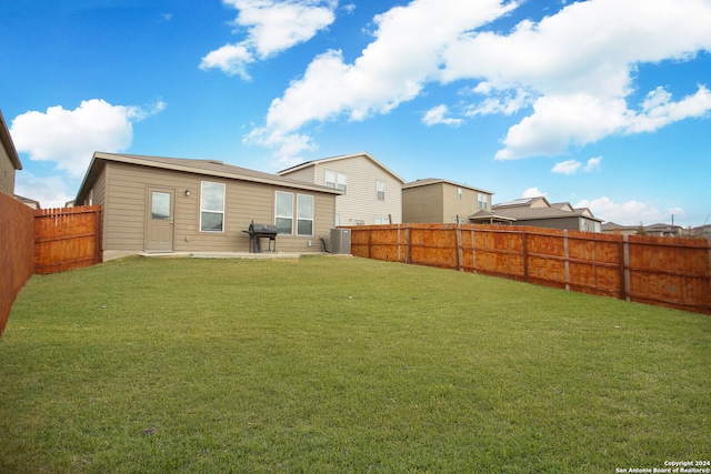 back of property featuring a patio area and a lawn