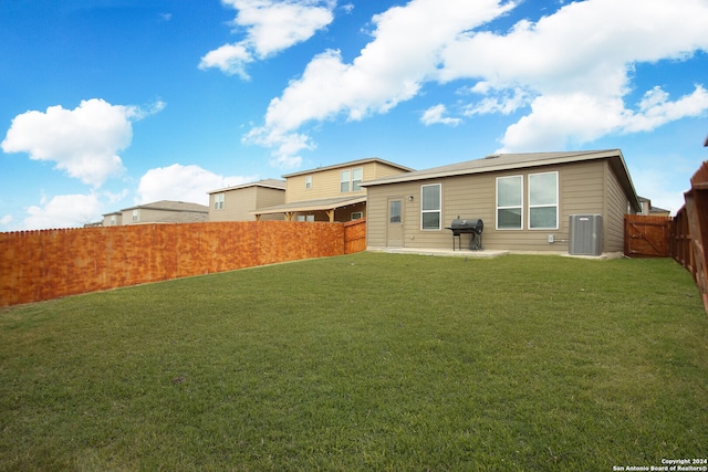 rear view of property with a patio area and a lawn