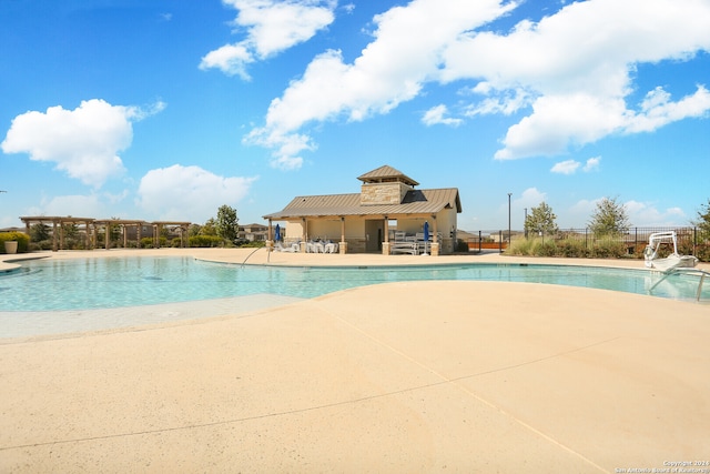 view of pool featuring a patio area and a water slide