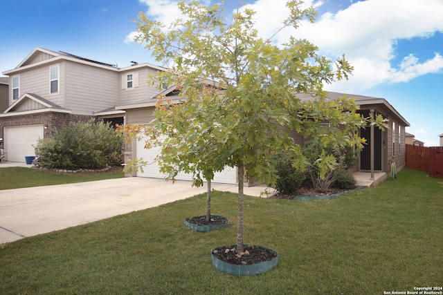 view of front of property featuring a front lawn and a garage