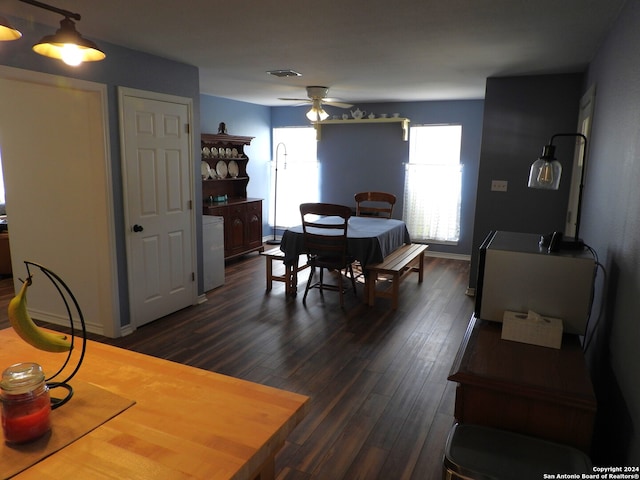 dining room with ceiling fan and dark hardwood / wood-style flooring