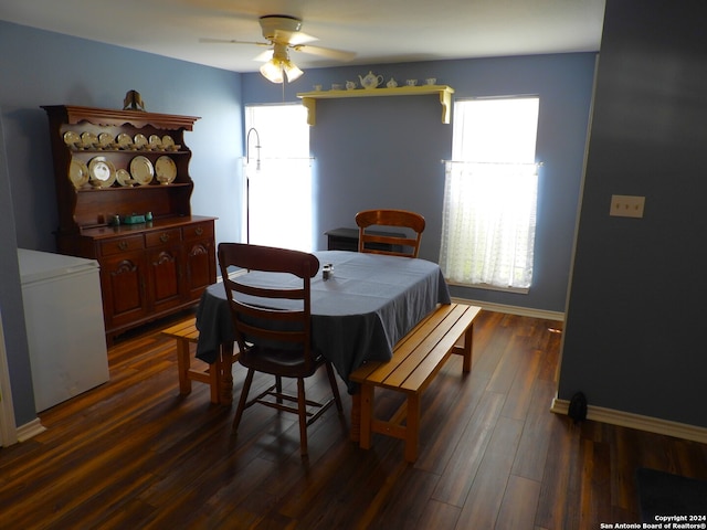 dining area featuring ceiling fan and dark hardwood / wood-style flooring