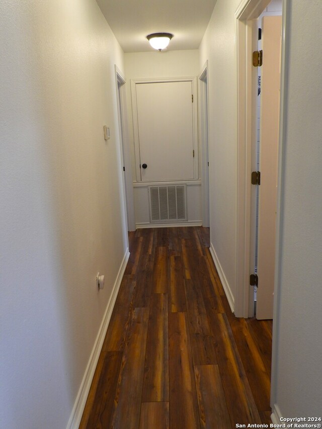 hallway with dark wood-type flooring