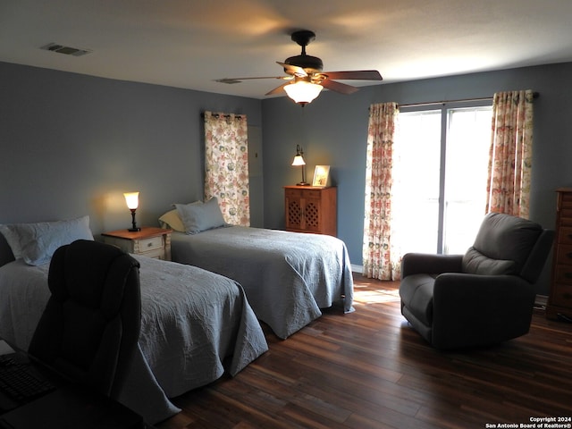 bedroom with dark wood-type flooring and ceiling fan